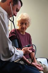 A doctor taking a patient's blood pressure